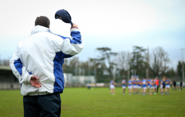 An umpire removes his hat for the National Anthem