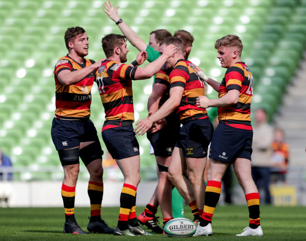 Adam Leavy celebrates with teammates after scoring a try