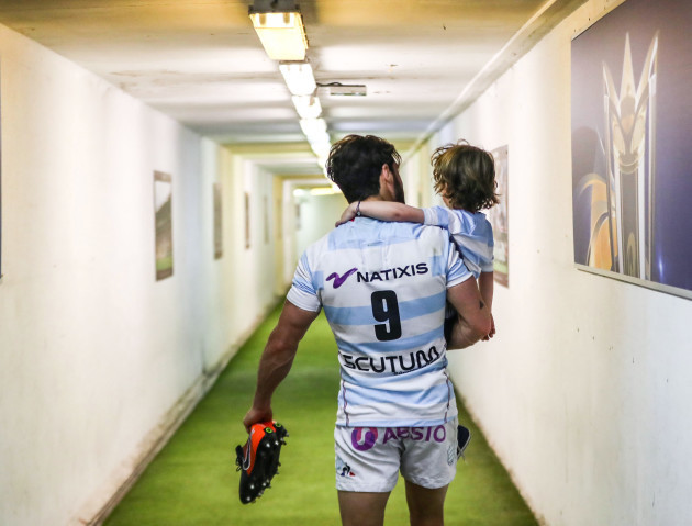 Maxime Machenaud walks down towards the dressing room with his son Gaspard after the game
