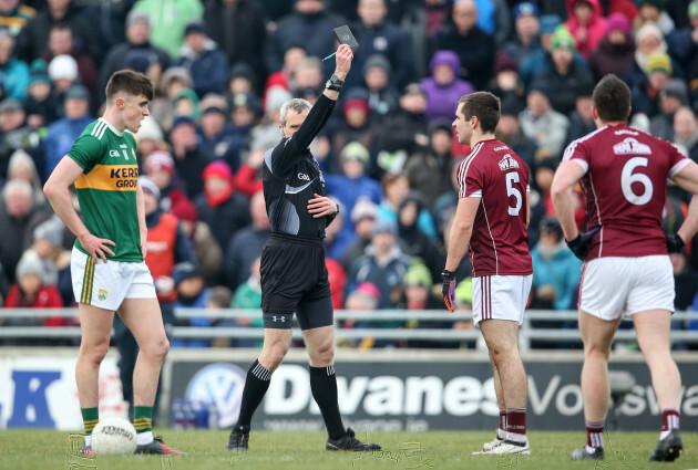 Cathal Sweeney is shown a black card by Fergal Kelly