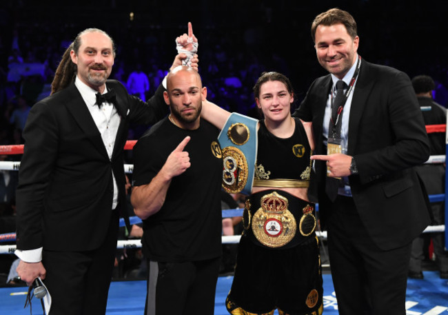 Katie Taylor celebrates with her trainer Ross Enamaitin and Eddie Hearn