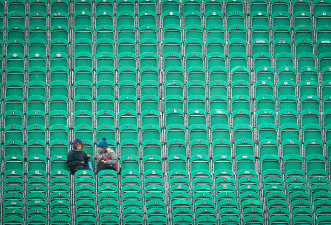 Young fans endure the rain during a pitch inspection