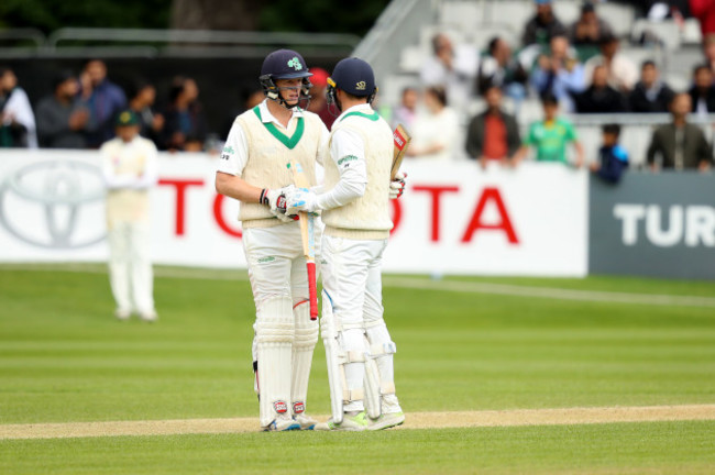 Kevin O'Brien congratulates Stuart Thompson on his half century