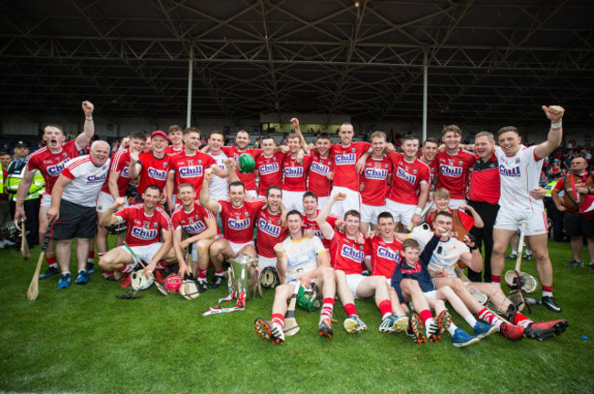 Cork players celebrate with the cup after the match