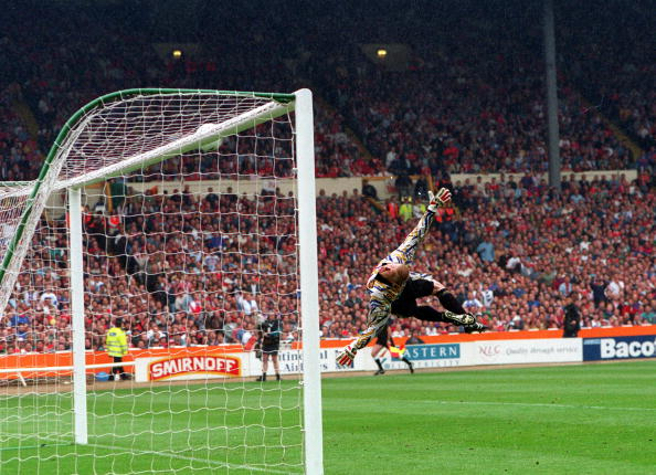 Football. 1994 FA Cup Final. Wembley. 14th May, 1994. Manchester United 4 v Chelsea 0. Manchester United goalkeeper Peter Schmeichel dives but is well beaten by Gavin Peacock's shot, which hits the crossbar and rebounds to safety.