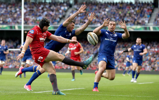 Leigh Halfpenny clears under pressure from Rob Kearney and James Lowe