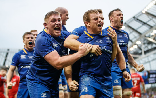 Sean Cronin celebrates scoring his sides third try with Tadhg Furlong and Jordan Larmour