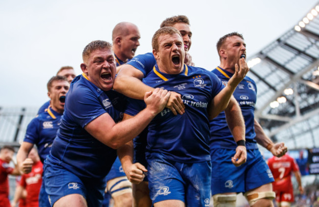 Sean Cronin celebrates scoring his sides third try with Tadhg Furlong and Jordan Larmour