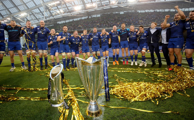 Leinster players celebrate with the PRO14 and Champions Cup trophies