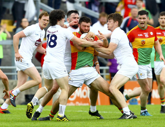 Shane Redmond is tackled by Chris Healy, Fergal Conway and Kevin Feely