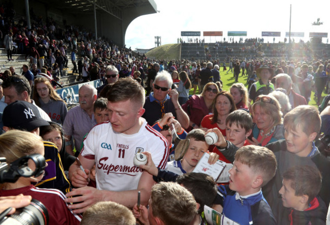 Joe Canning signs autographs for fans after the game