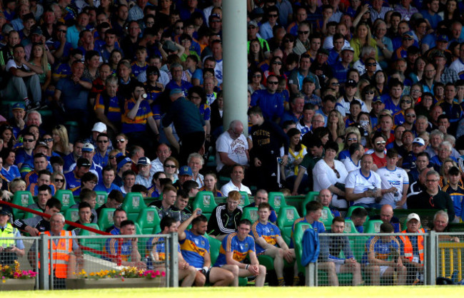 Michael Cahill looks on from the bench after he was red carded