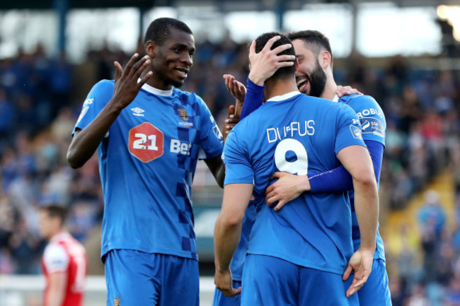 Courtney Duffus celebrates scoring a goal with David Webster and Izzy Akinade