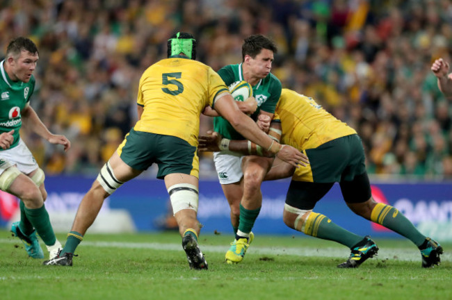 Joey Carbery tackled by Adam Coleman and Sekope Kepu