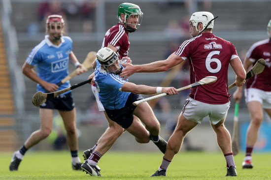 Jake Malone tackled by David Burke and Gearoid McInerney