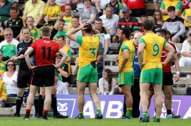 Neil McGee is shown a red card by referee Anthony Nolan