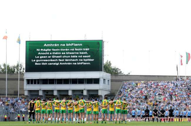 Two teams stand for the national anthem