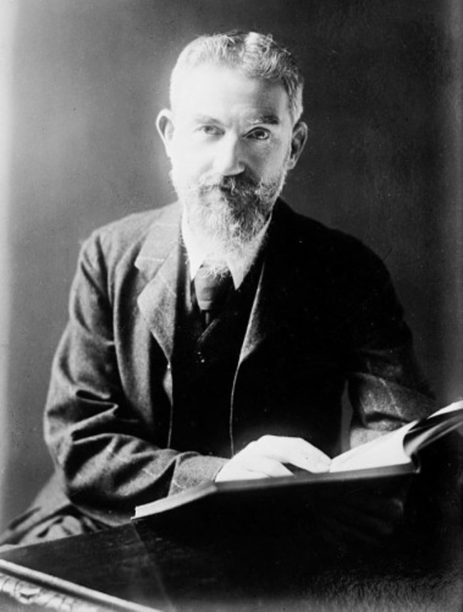 George_Bernard_Shaw_at_desk_with_book