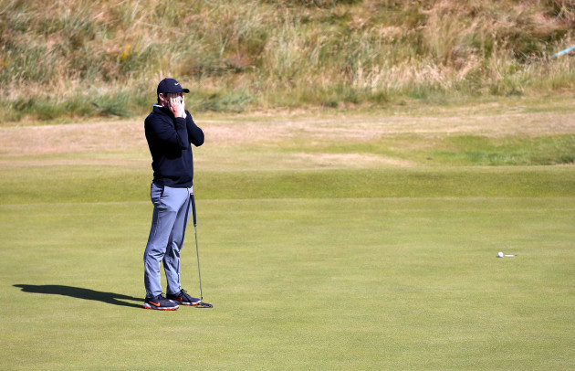 Rory McIlroy reacts after missing a putt on the 18th green