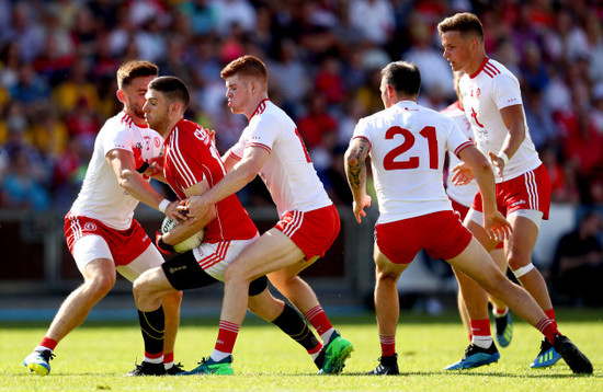 Padraig Hampsey, Cathal McShane, Cathal McCarron and Michael McKernan tackle Luke Connolly