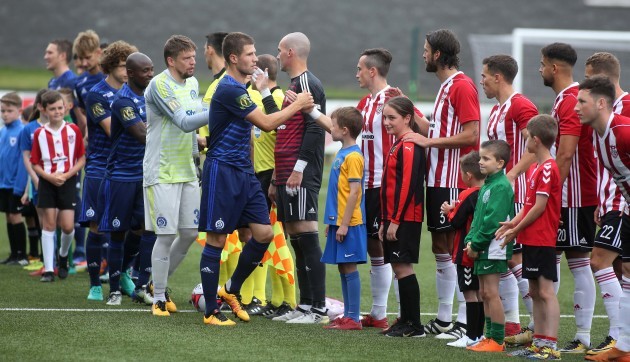 Players shake hands ahead of the game