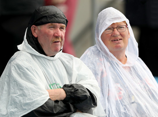 Spectators during a downpour