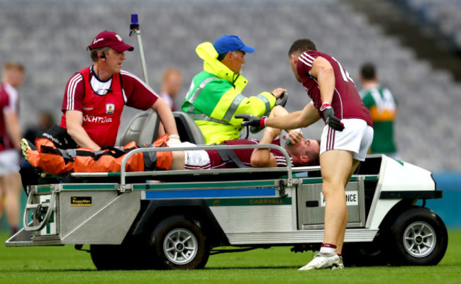 Damien Comer checks on the injured Paul Conroy