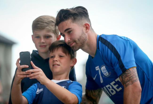 Sean Maguire takes a selfie with fans after the game
