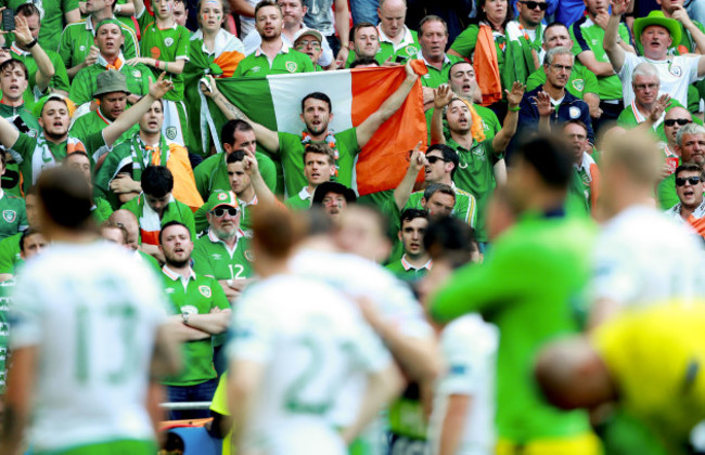 Fans sing as the players acknowledge them after the game