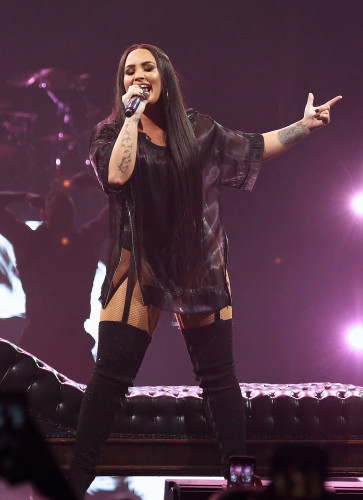 FL: Demi Lovato and DJ Khaled perform at the American Airlines Arena.