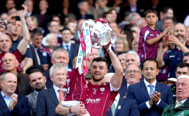 Adrian Tuohy and his son Jamie lifts the Liam McCarthy cup