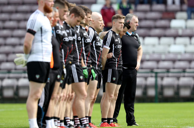 Cathal Corey stands with his team during the national anthem