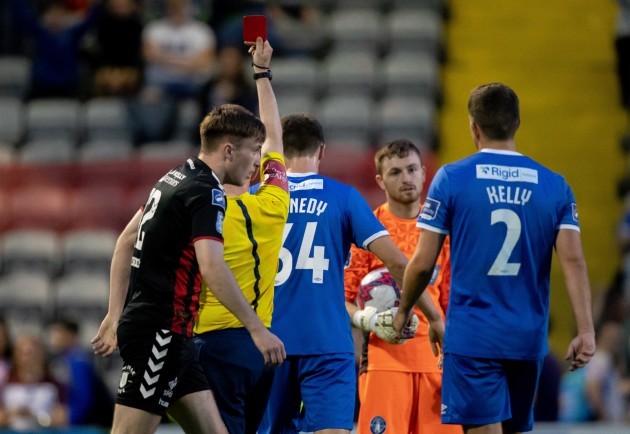 Colman Kennedy receives a red card after giving away a penalty