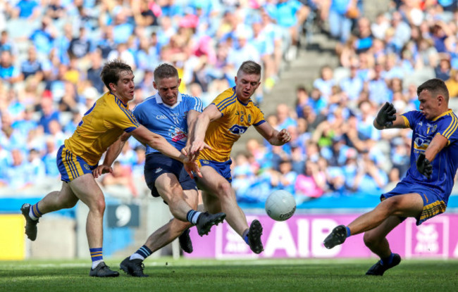 Eoghan O'Gara scores a goal under pressure from David Murray and Darra Pettit