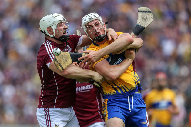 Joe Canning with Conor Cleary battle for possession