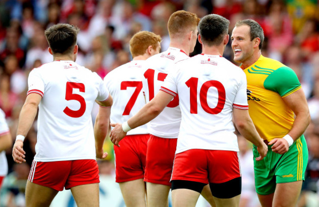 Michael Murphy celebrates a score in front of Cathal McShane