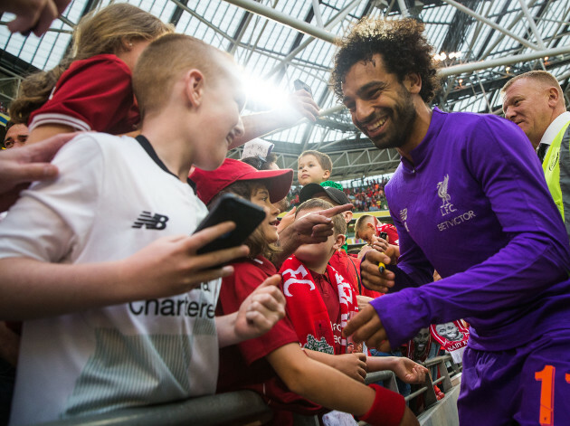 Mohamed Salah signs autographs after the game