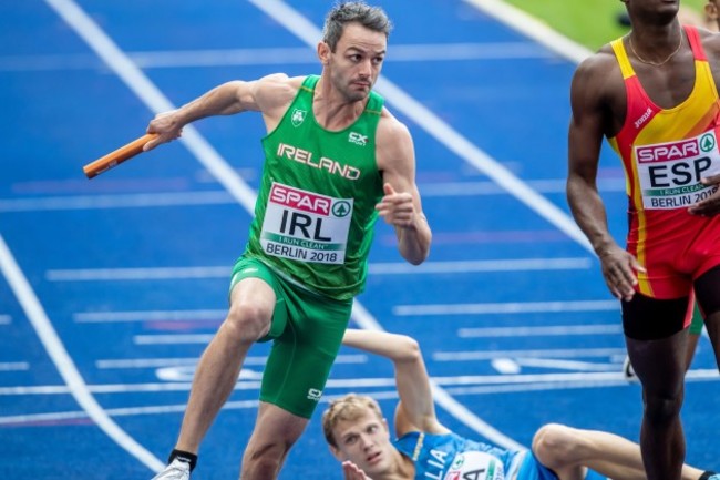 Thomas Barr is forced to jump a fellow athlete as he takes the baton from Leon Reid