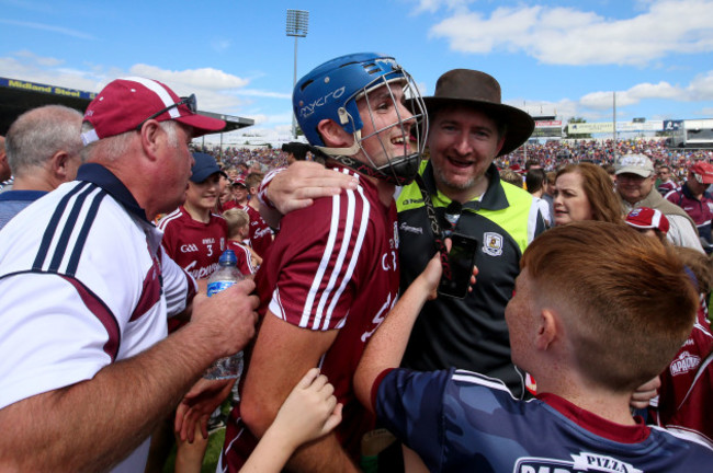 Johnny Coen celebrates after the game with fans