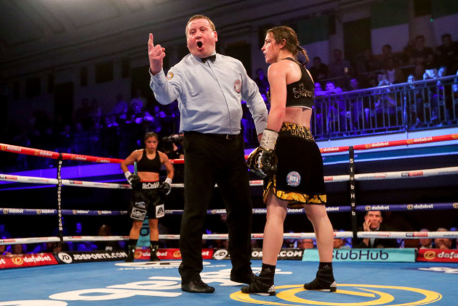 Referee Howard Foster deducts a point from Katie Taylor