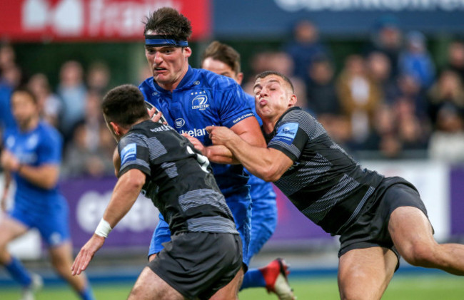 Tom Daly tackled by Adam Radwan and James Elliott