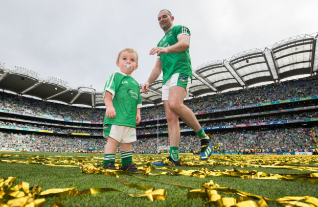 Tom Condon celebrates after the game with his son Nicky