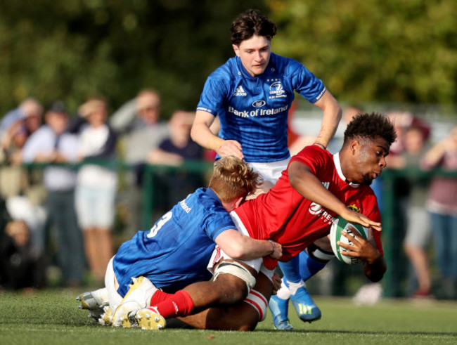 Daniel Okeke is tackled by Sam Illo