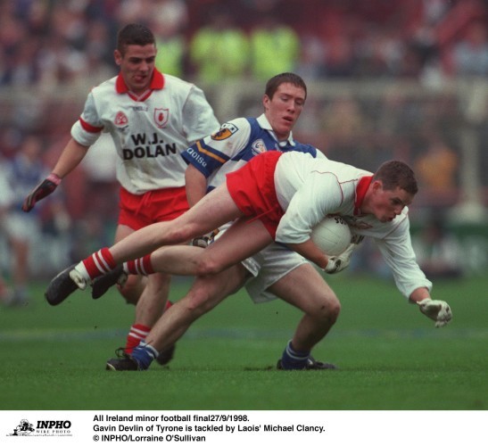 Gavin Devlin of Tyrone is tackled by Laois' Michael Clancy