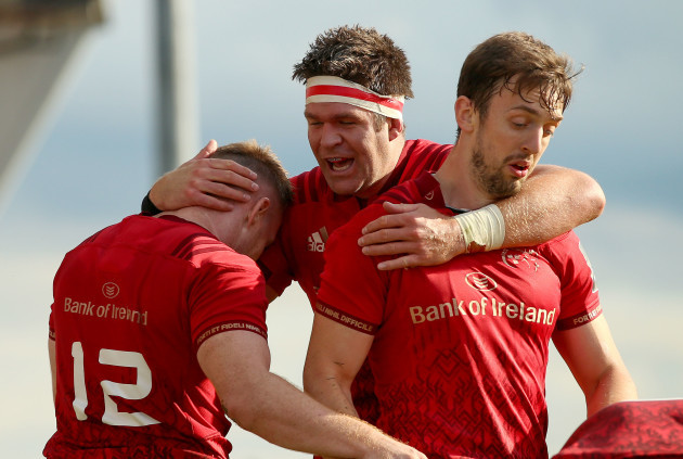 Rory Scannell celebrates scoring a try with Darren Sweetnam and Billy Holland