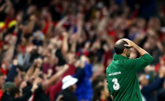 watches on as Wales score their fourth goal