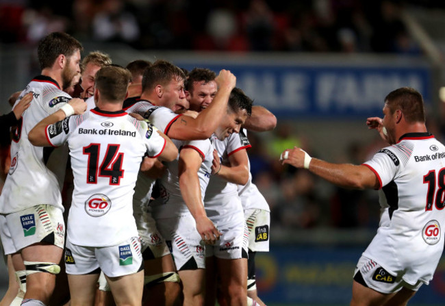 John Cooney celebrates with teammates at the final whistle after kicking the winning penalty