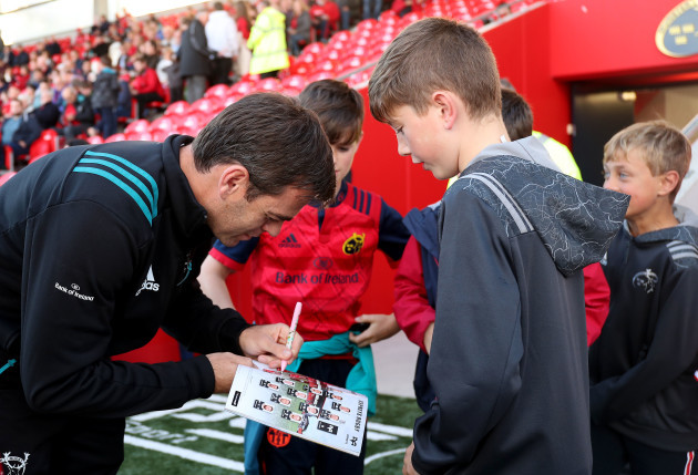 Johann van Graan signs autographs for fans before the game