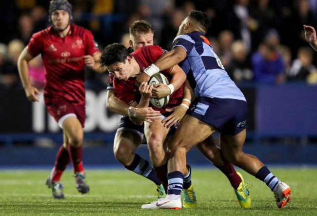 Joey Carbery tackled by Gareth Anscombe and Willis Halaholo