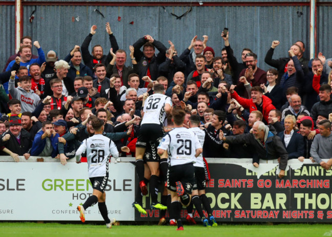 Ali Reghba celebrates scoring a goal with the fans